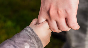 A father and son holding hands